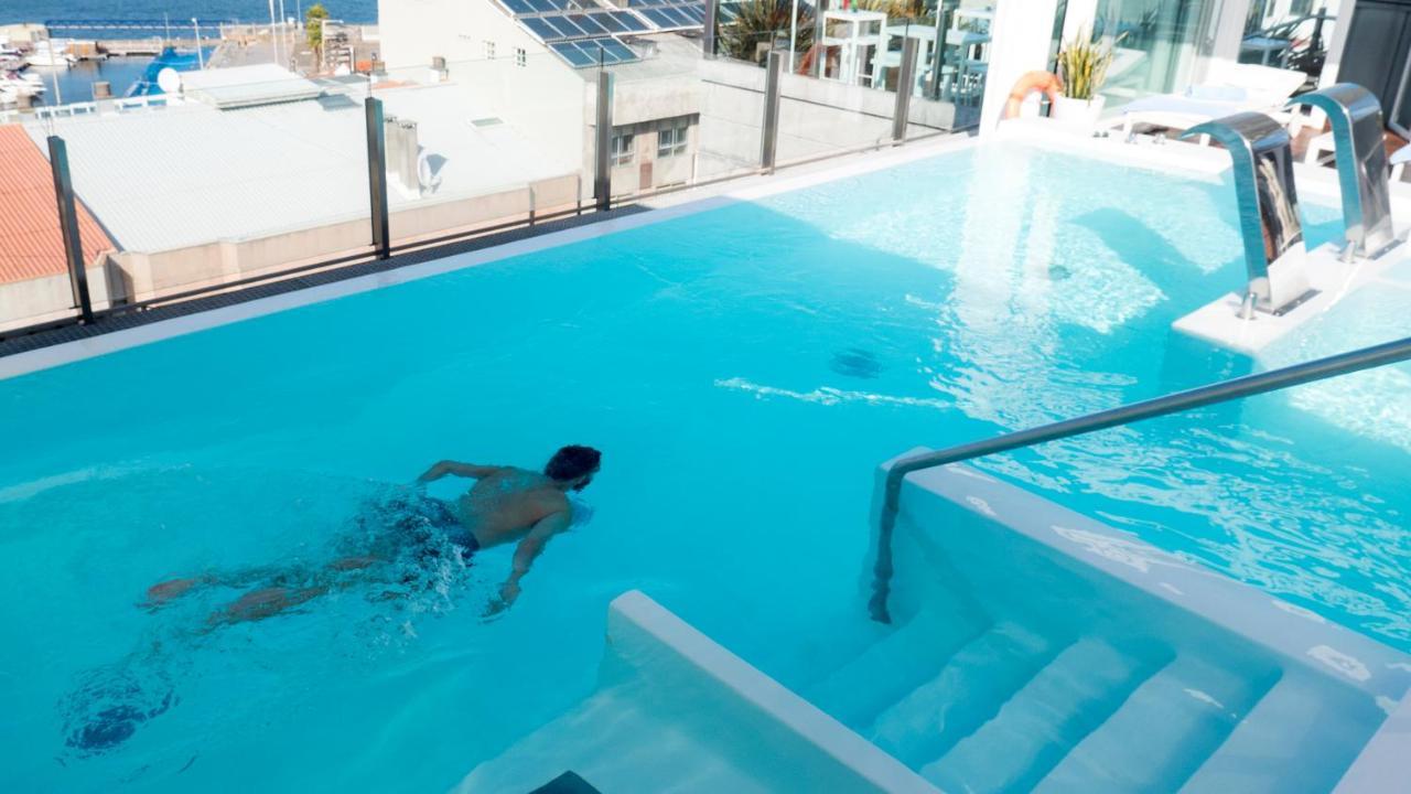 그랜 호텔 나가리 부티크 앤드 스파 비고 외부 사진 A man swimming in a rooftop pool
